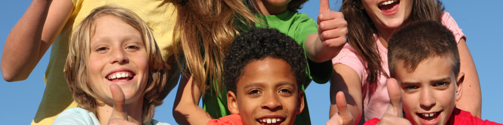 Group of happy children with thumbs up